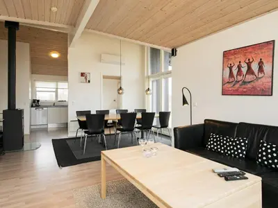 a living room with a table and black chairs at 8 person holiday home in Brovst-By Traum in Brovst