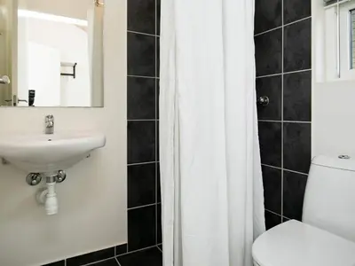 a bathroom with a sink and a toilet and a mirror at 8 person holiday home in Brovst-By Traum in Brovst