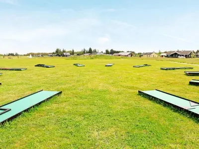 a large field with benches in the grass at 8 person holiday home in Brovst-By Traum in Brovst