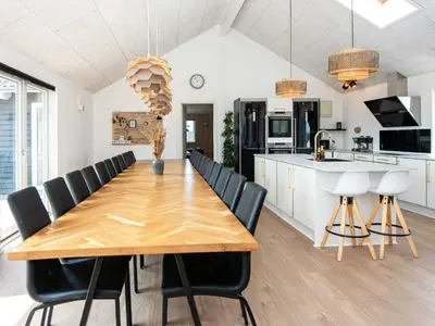 a kitchen and dining room with a wooden table and chairs at Luxury Retreat by the Sea - By Traum Ferienwohnungen in Harboør