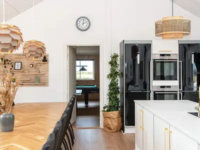 a kitchen with a pool table in the distance at Luxury Retreat by the Sea - By Traum Ferienwohnungen in Harboør