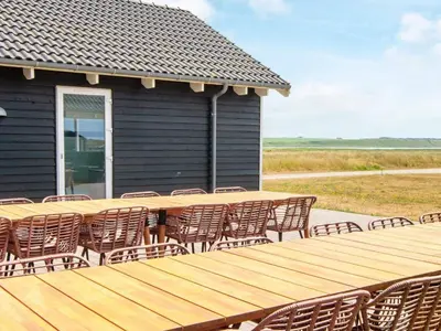 a wooden table and chairs on a house at Luxury Retreat by the Sea - By Traum Ferienwohnungen in Harboør