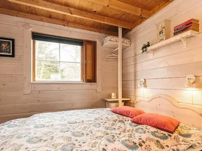 a bedroom with a bed in a room with a window at 6 person holiday home in Roslev-By Traum in Flovtrup
