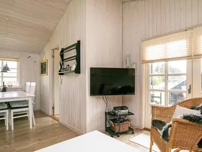 a living room with a flat screen tv on the wall at 6 person holiday home in Blokhus-By Traum in Blokhus