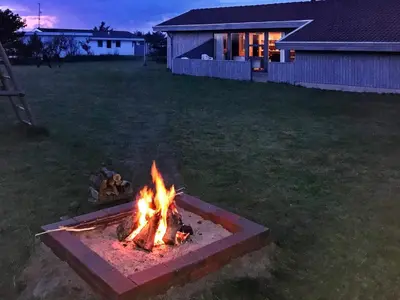 a fire pit in a yard at night at 8 person holiday home in Vestervig in Vestervig