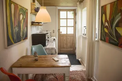 a hallway with a table and chairs in a room at Astrup vig Spa og Sauna in Roslev