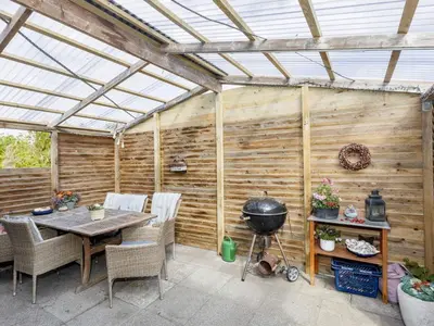 a greenhouse with a table and a grill in a patio at 8 person holiday home in Løgstør-By Traum in Trend