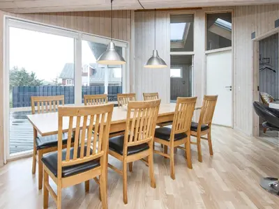 a dining room with a wooden table and chairs at 10 person holiday home in Harboøre-By Traum in Harboør