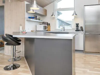 a kitchen with a counter and a refrigerator at 10 person holiday home in Harboøre-By Traum in Harboør