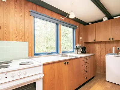 a kitchen with a stove and a sink and a window at 5 person holiday home in Højslev-By Traum in Bøstrup