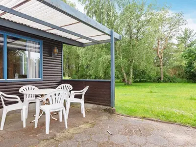 a patio with a table and chairs on a house at 5 person holiday home in Højslev-By Traum in Bøstrup