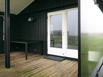 a screened in porch with a door and a table at 6 person holiday home in Vinderup-By Traum in Vinderup