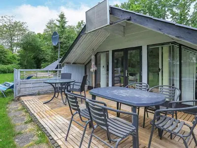 a patio with tables and chairs on a deck at 6 person holiday home in Roslev-By Traum in Vester Grønning