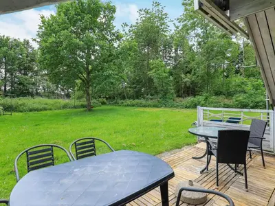 a patio with a table and chairs on a deck at 6 person holiday home in Roslev-By Traum in Vester Grønning