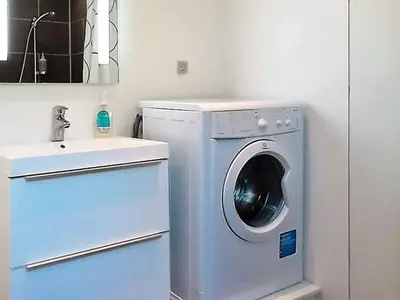 a bathroom with a washing machine and a sink at 5 person holiday home in Harboøre in Harboør