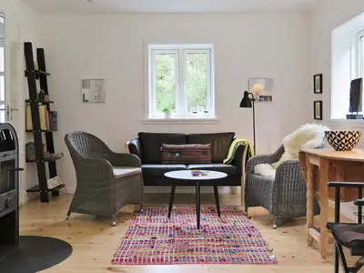 a living room with a couch and chairs and a table at 5 person holiday home in Harboøre in Harboør