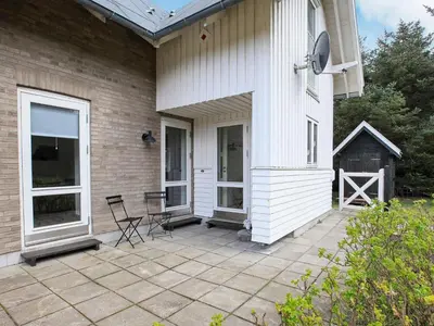 a patio with two chairs and a house at 5 person holiday home in Harboøre in Harboør