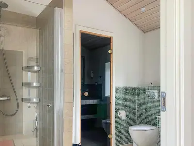 a bathroom with a toilet and a glass shower at 6 person holiday home in Spøttrup-By Traum in Knud