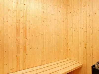 a wooden wall with a bench in a sauna at 6 person holiday home in Spøttrup-By Traum in Knud