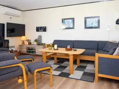 a living room with a blue couch and a table at 6 person holiday home in Lemvig-By Traum in Trans