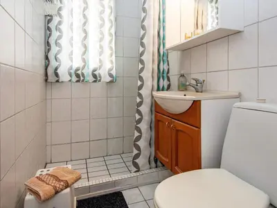 a bathroom with a toilet and a sink and a shower at 6 person holiday home in Lemvig-By Traum in Trans