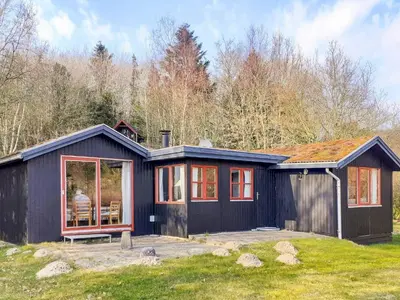 a black house with a person sitting inside of it at 6 person holiday home in Spøttrup-By Traum in Lihme