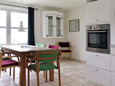 a kitchen and dining room with a table and chairs at 4 person holiday home in Lemvig-By Traum in Trans