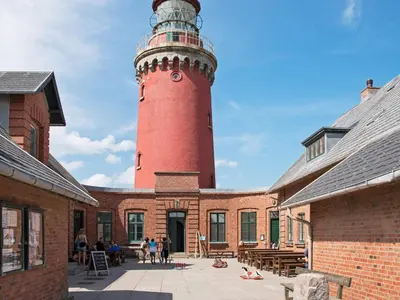 a red lighthouse sitting on top of a brick building at 4 person holiday home in Lemvig-By Traum in Trans