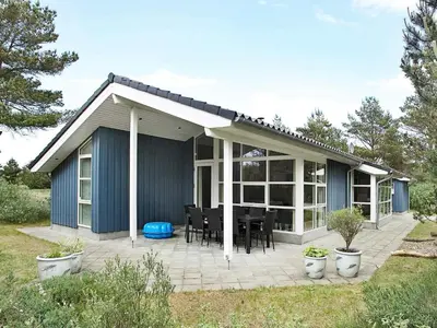 a house with a patio with a table and chairs at 10 person holiday home in Fjerritslev-By Traum in Torup Strand