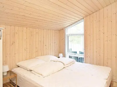 a white bed in a room with a window at 10 person holiday home in Fjerritslev-By Traum in Torup Strand