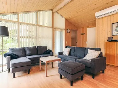 a living room with a couch and chairs and a table at 10 person holiday home in Fjerritslev-By Traum in Torup Strand