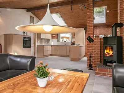 a living room with a table and a fireplace at 6 person holiday home in Hurup Thy-By Traum in Sindrup