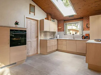a large kitchen with a skylight in the ceiling at 6 person holiday home in Hurup Thy-By Traum in Sindrup