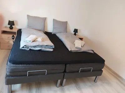 a bed with two mattresses and two pillows on it at Venos Home in Lemvig