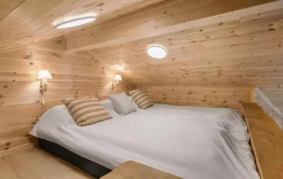 a bedroom with a bed in a wooden cabin at 3 Bedroom Gorgeous Home In Skals in Skals
