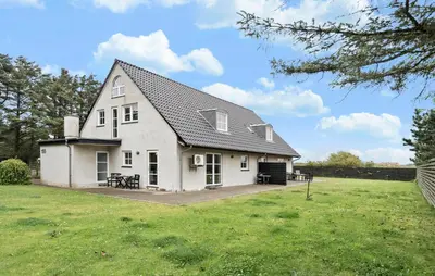 a large white house with a grass yard at Stunning Home In Harboøre With Wifi in Harboør