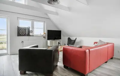 a living room with two leather chairs and a tv at Lovely Home In Harboøre With Wifi in Harboør