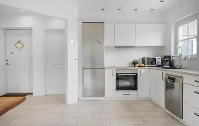 a kitchen with white cabinets and stainless steel appliances at Lovely Home In Harboøre With Wifi in Harboør