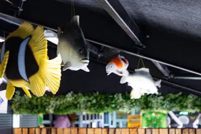 a group of fish hanging from the ceiling at Stort sommerhus - Legeland for store og små in Pandrup