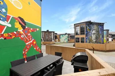 a building with a mural and a bench on the roof at Funart 4 in Pandrup
