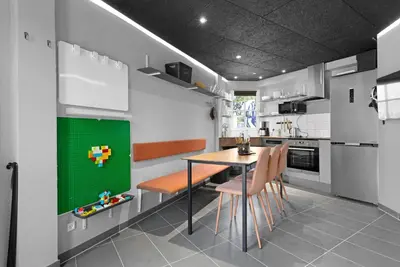 a kitchen with a table and some chairs and a tableablish at Funart 7 in Pandrup