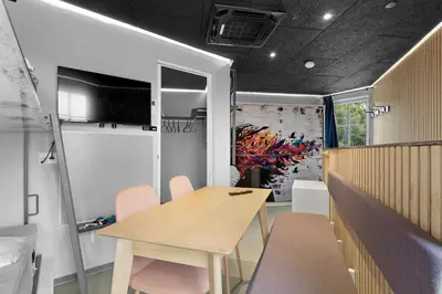 a dining room with a wooden table and chairs at Funart 13 in Pandrup