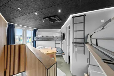 a dorm room with a desk and bunk beds at Funart 13 in Pandrup