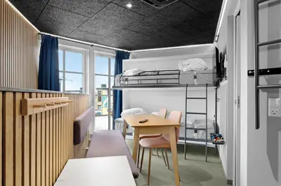 a room with a bunk bed and a table at Funart 15 in Pandrup