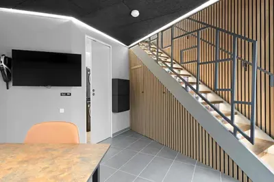 a room with a staircase with a tv and a table at Funart 8 in Pandrup