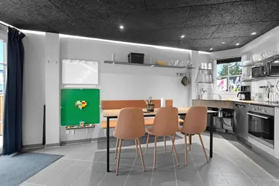 a kitchen with a table and chairs in it at Funart 6 in Pandrup