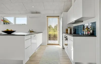 a kitchen with white cabinets and a large window at Beautiful Home In Nykøbing M With Wifi in Alsted