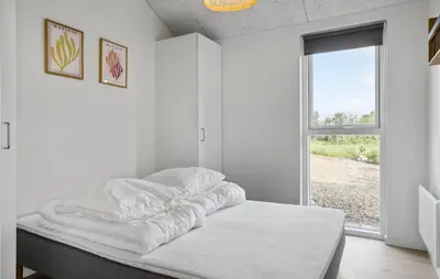 a white room with a bed with a window at Beautiful Home In Nykøbing M With Wifi in Alsted