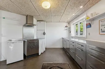 a kitchen with stainless steel appliances and a window at Spacious Holiday Home With Views Over Limfjorden in Jørsby