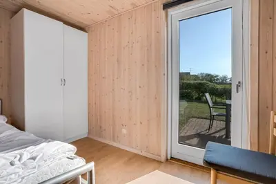 a bedroom with a bed and a sliding glass door at 4 bedrooms and a beautiful view in Vinderup
